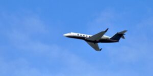 private jet flying over Grand Rapids skyline