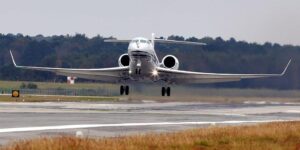 luxury private jet on runway with Nantucket island in background