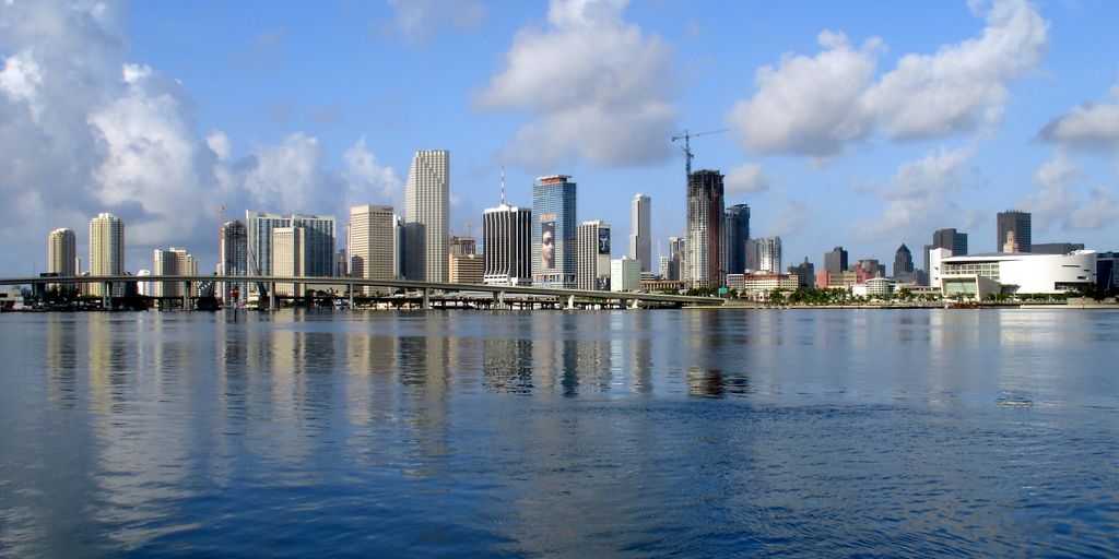 luxury private jet on runway Miami skyline